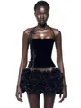 Detailed close-up of a black velvet corset dress featuring a voluminous ruffled mini skirt - XS / Top And Bottom / Velvet Black