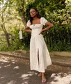Detailed visual of a white French floral midi dress featuring puff sleeves and elegant front slit - White Floral