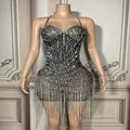 Detailed view of sheer black mini dress with glittering rhinestones and silver fringe detail - S / Black