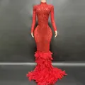 Elegant red evening gown detail featuring sparkling rhinestones and dense feather mermaid hem. - S / Red