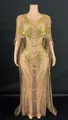 Detailed view of the gold sequin patterns on a nude mesh evening gown with cape. - S / Top And Bottom / Gold