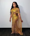 Elegant golden sheer mesh evening gown featuring sequins and dramatic cape sleeve detail - S / Top And Bottom / Gold