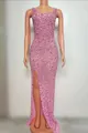 Detail view of pink sequined embroidery and high slit on this slim fit evening gown - Pink