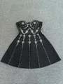 Dettaglio di un abito bandage nero con intricati ricami floreali in strass lucidi - Taglia L / Top e Pantaloni / Nero