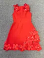 Macro detail of red bandage dress featuring 3D floral appliqués and sparkling beadwork - S / Dresses / Red