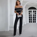 Detail shot of black off-the-shoulder wide-leg jumpsuit with white Greek key pattern - L / Top And Bottom / Black