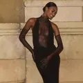 Model wearing a sexy black lace halter dress with matching gloves against a stone wall. - S / Top And Bottom / Black