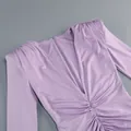 Detalle de vestido morado con cuello en V, manga larga y cintura fruncida. - Púrpura