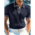 Close-up detail of men's navy blue ribbed short sleeve polo shirt with white contrast tipping - S / Tops / Navy Blue
