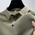 Detailed macro view of khaki textured quick-dry polo shirt showing fabric elasticity - Army Green