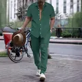 Close-up look of a stylish men's green vertical striped shirt and long pants set. - Dark Green