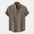 Detail of men's brown cotton linen shirt featuring stand collar and chest pocket - 3XL / Tops / Khaki