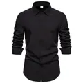 Detail view of a men's classic long-sleeved casual black shirt with button-down front. - Black
