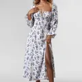Close-up detail of white floral midi dress featuring a square neck and high thigh slit. - S / Top And Bottom / White Floral