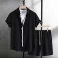 Detailed view of a textured black men's summer shirt and shorts set on clothing hangers - S / Top And Bottom / Black
