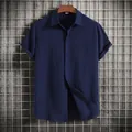 Detail showing the rich texture and navy color of this loose men's short sleeve shirt - Navy Blue