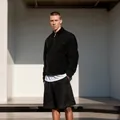 Men's minimalist black zipper jacket with lapel collar in a modern outdoor setting - M / Tops / Black