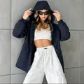 Trendy model wearing navy blue waterproof hooded windbreaker with white sporty pants - S / Tops / Navy Blue