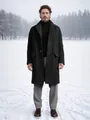 Detailed view of a man wearing a single-breasted charcoal long wool coat in snow - M / Tops / Black