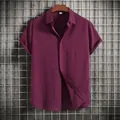 Detail view of a men's burgundy short-sleeved shirt featuring a textured fabric finish - 3XL / Tops / Burgundy