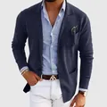 Close-up detail of a navy blue slim fit blazer for men worn over a blue striped shirt - Navy Blue