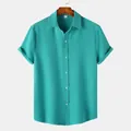 Detailed texture of men's short-sleeve teal shirt with crinkled fabric and buttons - M / Tops / Teal