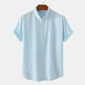 Detail of light blue men's cotton linen henley shirt with stand collar and buttons - Light Blue