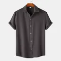 Professional close-up of a men's dark grey short-sleeve shirt with rich fabric texture details - M / Tops / Dark Gray