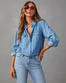 Detail of a women's light blue long-sleeved denim shirt with two buttoned chest pockets - S / Tops / Dark Blue