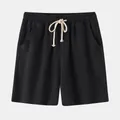 Detailed view of men's black cotton linen shorts with a white drawstring waist - S / Bottoms / Black