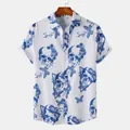 Detailed view of blue skull and butterfly print on men's white short-sleeved beach shirt - White Blue Floral Skull