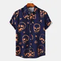 Close-up of the orange skull and cross pattern on a navy blue short-sleeve shirt - Navy Blue Orange Skull