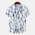 Detailed view of the seashell print on a white men's short-sleeved beach shirt - White Blue Shell Print (C212)