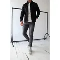 Stylish men's casual long-sleeved black shirt paired with slim gray jeans and sneakers - Black