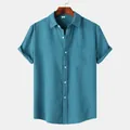 Macro view of teal waffle-textured fabric on a men's short-sleeved casual shirt. - Teal