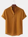 Macro view of mustard yellow men's linen short sleeve shirt featuring a mandarin collar - Brown