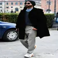Detail of man wearing black thickened hooded woolen jacket in a stylish urban street setting - M / Tops / Black