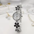 Close-up of elegant silver women's bracelet watch with black enamel floral design - Silver Black