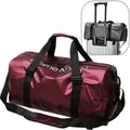 Large burgundy sports duffel bag featuring a suitcase sleeve and adjustable shoulder strap - Burgundy