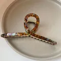 Large tortoise shell acetate hair claw clip with an elegant twisted loop design for women - Coffee Tortoise Shell