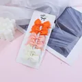 Set of six mini grosgrain ribbon hair bows in orange, pink, and cream on a card. - Orange Pink Cream Combo