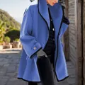 Detailed side view of a bright blue wool coat with stylish black contrast piping - Blue