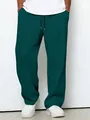 Close-up of men's dark green waffle knit trousers showing the texture and drawstring detail - S / Bottoms / Dark Green