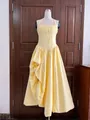 Yellow French style halter pleated maxi dress with irregular hem shown on mannequin - Light Yellow