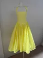 Detailed front view of a vibrant yellow halter neck midi dress with pleated skirt. - S / Top And Bottom / Yellow