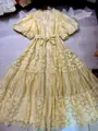 Detail view of a French vintage yellow lace maxi dress with elegant puff sleeves - S / Yellow