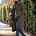 Close-up of brown fuzzy lamb wool long coat texture and fit on a model outdoors - S / Tops / Dark Gray