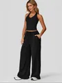 Full body model shot wearing a black halter neck top and matching wide leg pants set. - S / Top And Bottom / Black