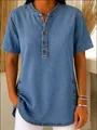 Detail view of women's denim short sleeve shirt featuring button placket and side buttons - S / Tops / Blue