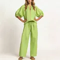 Detailed view of the lime green loose top and wide-leg trousers set on a model - S / Top And Bottom / Light Green
